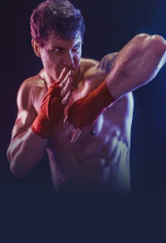 Boxeador con vendas rojas en los puños en posición de guardia, con iluminación azul y roja